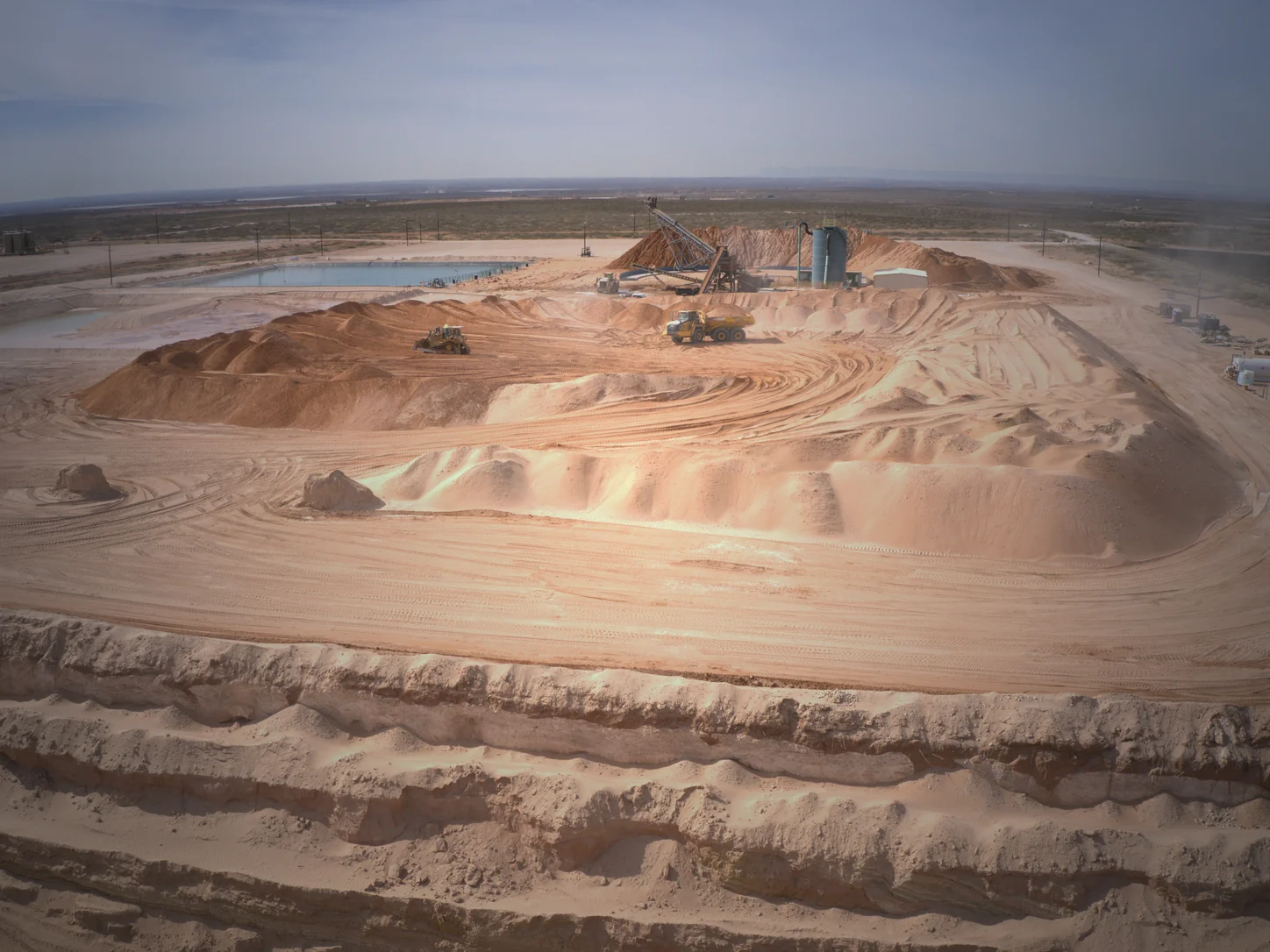Aerial view of SanBar Stateline Yard operations, sand inventory, conveyors, and trucks